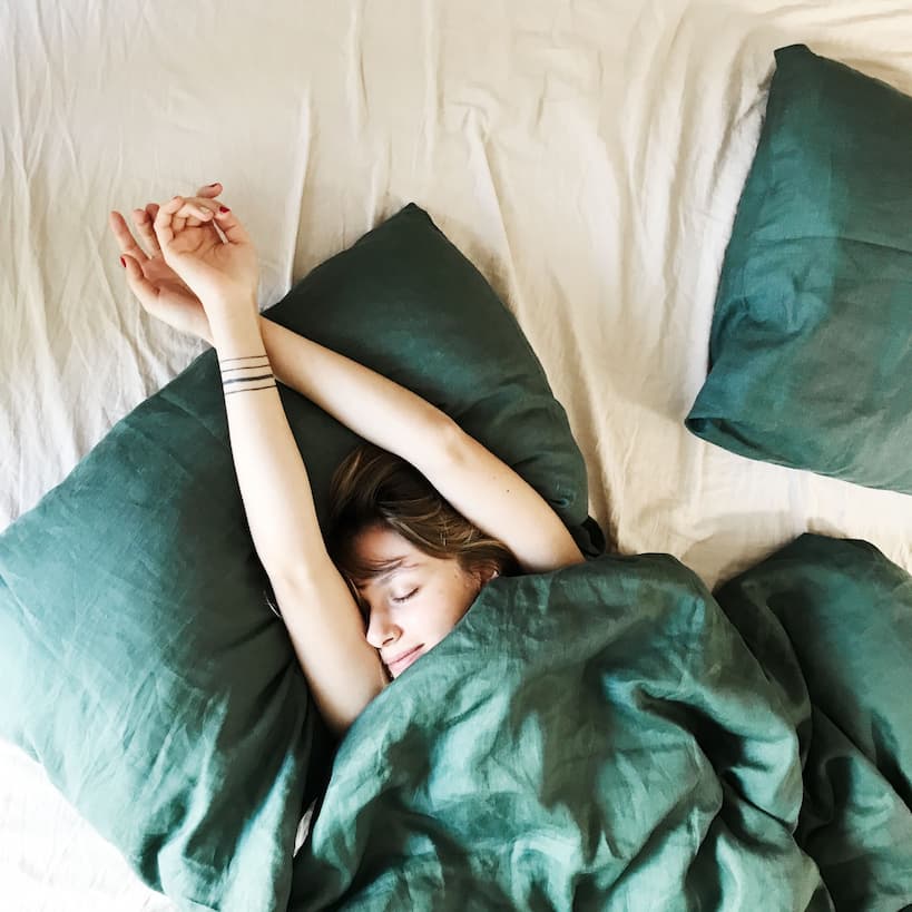 girl sleeping on a linen bed