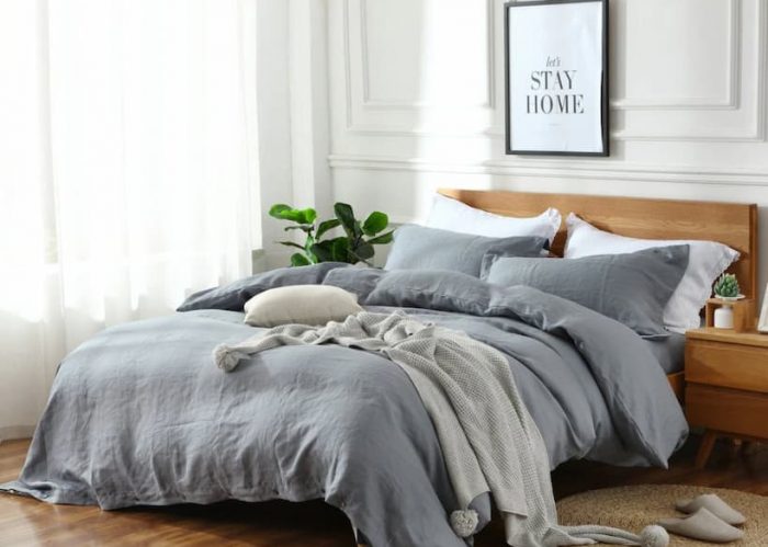 gray linen bedding with decorative throw and pillows