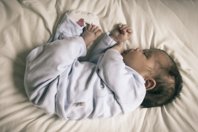 picture of a baby sleeping in a blue cotton pajamas 