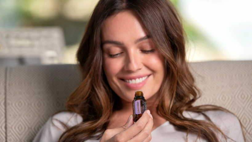 women breathe in the scent of lavender essential oil