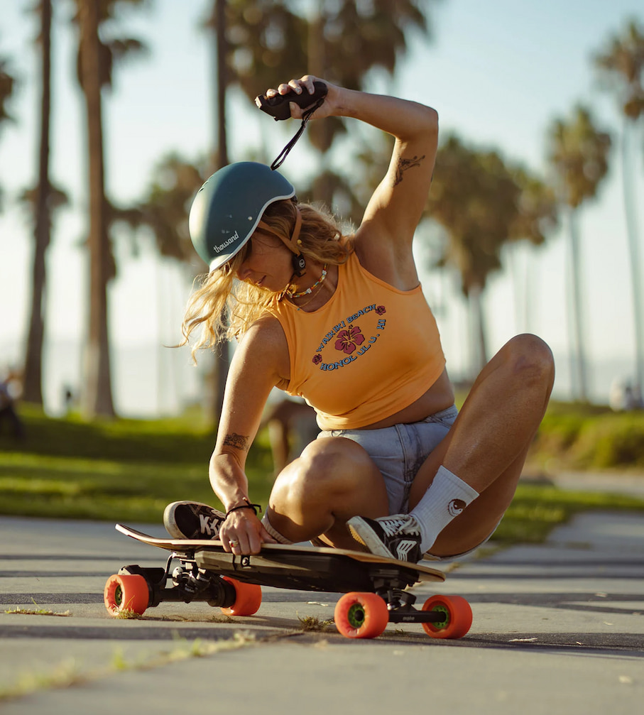 woman riding evolve electric skateboard