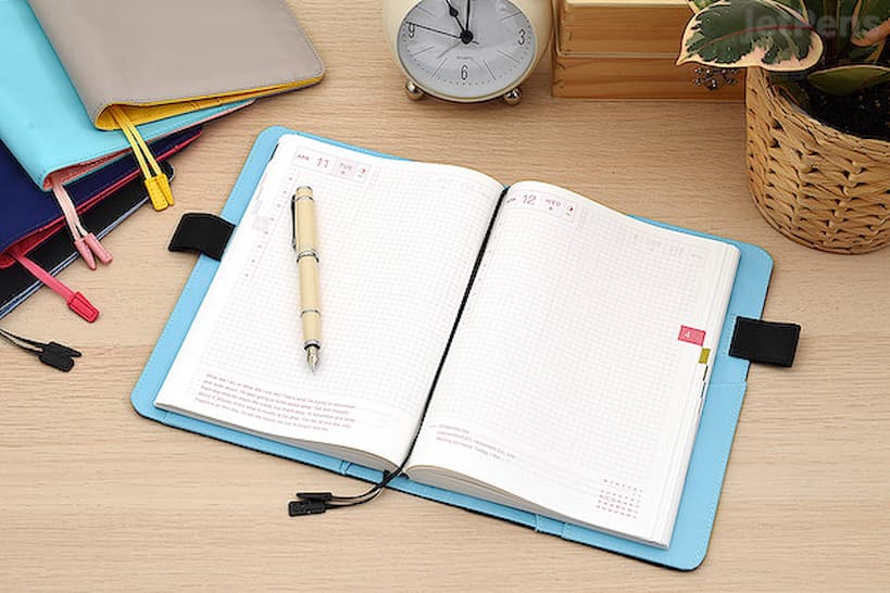 Hobonichi Techo Planner openned on the table with pen on it