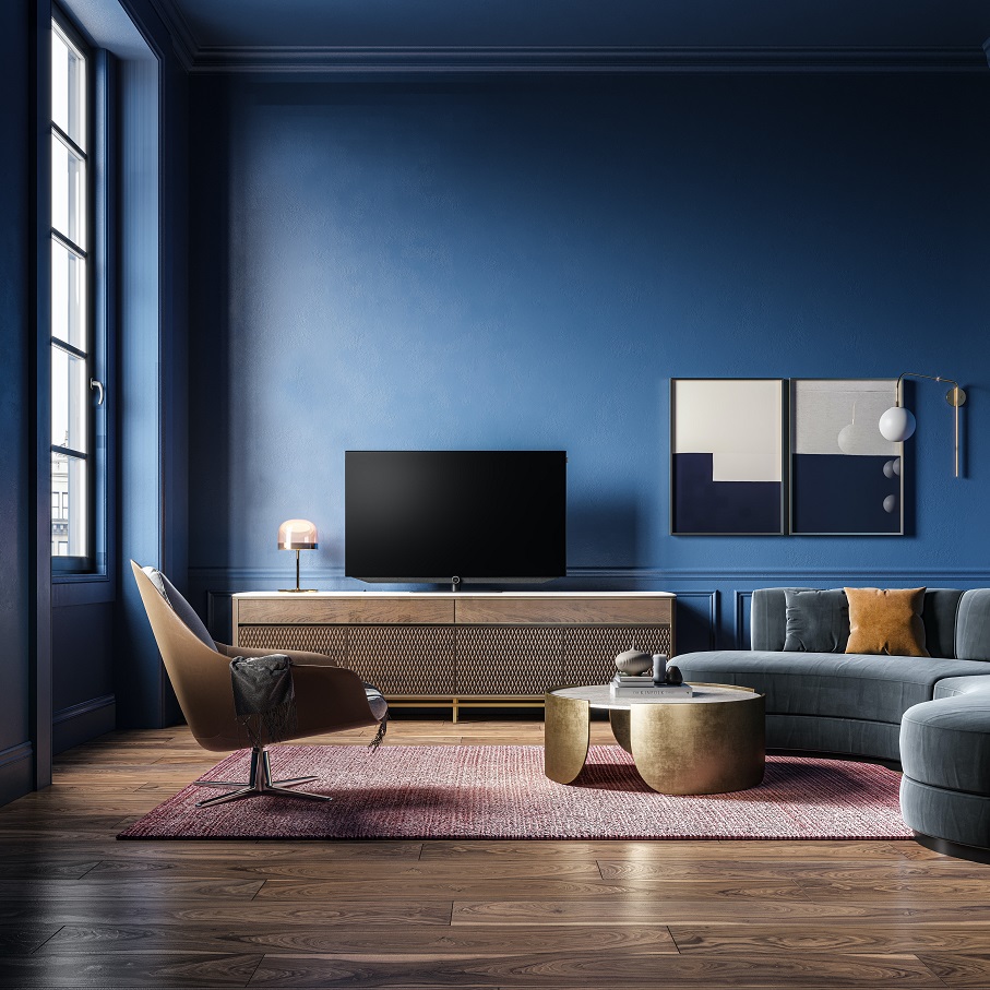 living room with blue walls with sofa, chair and a tv cabinet